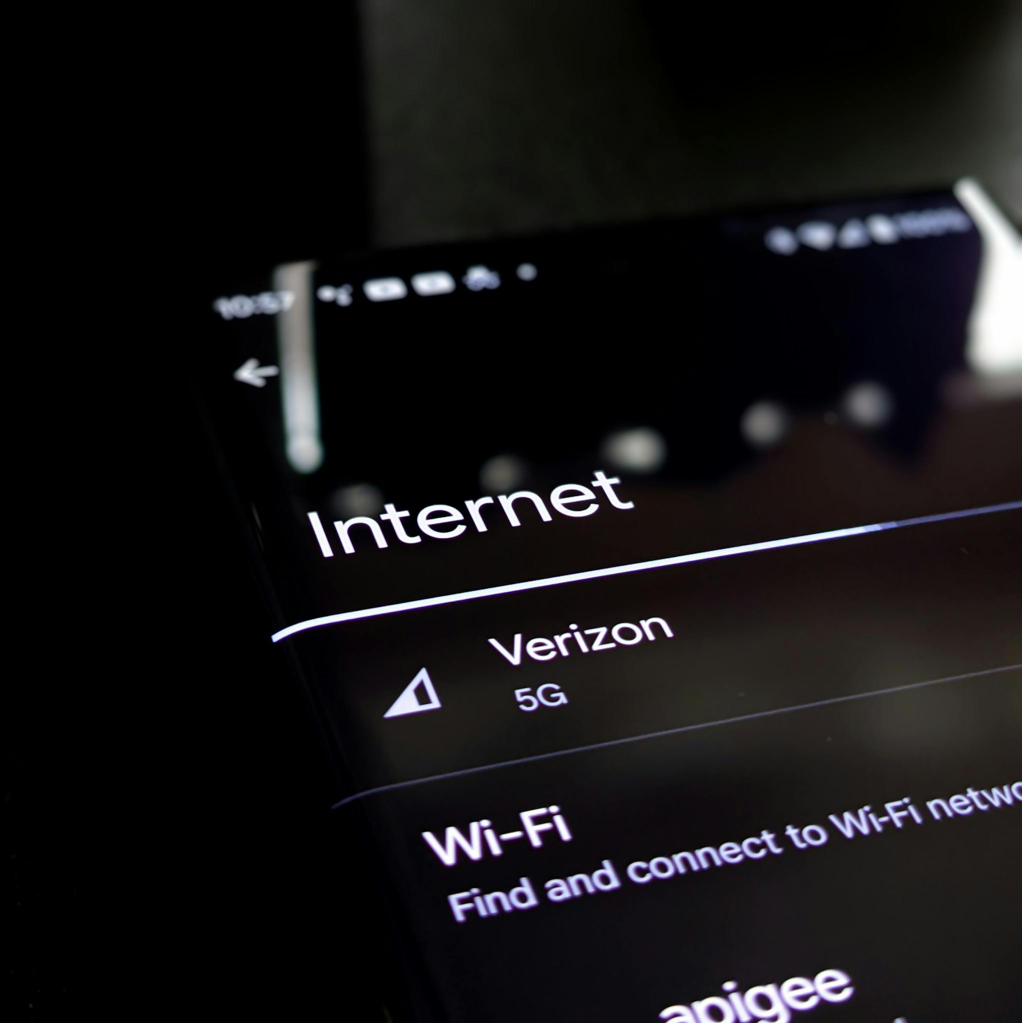 Close-up of a smartphone screen displaying internet connection details with Verizon 5G and Wi-Fi options.